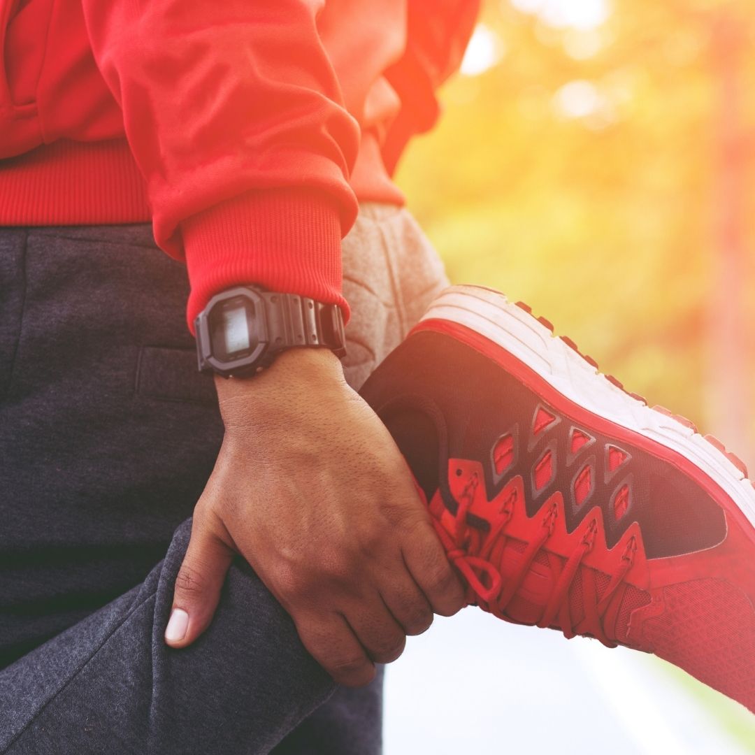 A runner stretching their hamstring